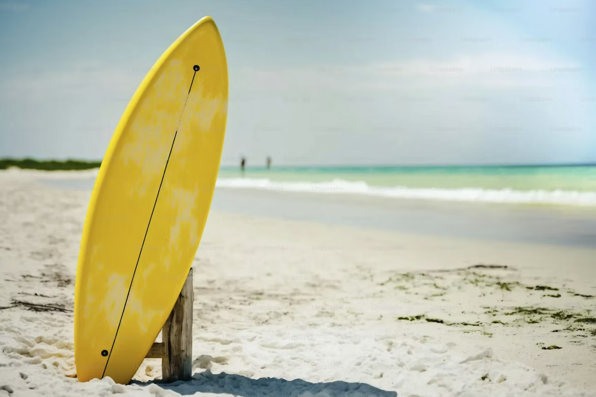 Yellow surfboard on a beach